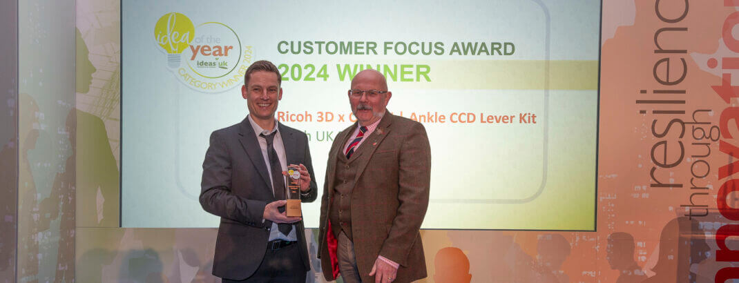 Ricoh 3D's Senior Engineer and Medical Lead, Richard Minifie collecting the IdeasUK 'Customer Focus' award.