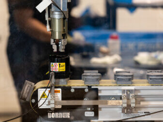 3D-printed components attached to an operations line in Ricoh UK Products Ltd's Toner Bottle Recycling area.